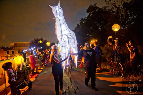 Amie Robb (left) and Jen Long (right) steer a horse lantern during the Atlanta Beltline Lantern Parade on Saturday, September 6, 2014. 