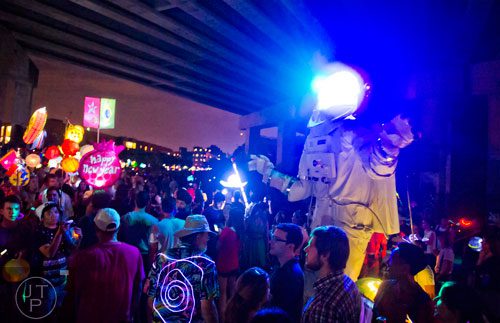 The Atlanta Beltline Lantern Parade passes by a giant astronaut on Saturday, September 6, 2014. 