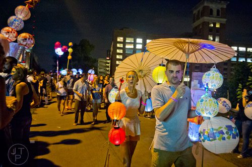 Ben Londillo (right) and Emily Heath carry lanterns past City Hall East during the Atlanta Beltline Lantern Parade on Saturday, September 6, 2014.