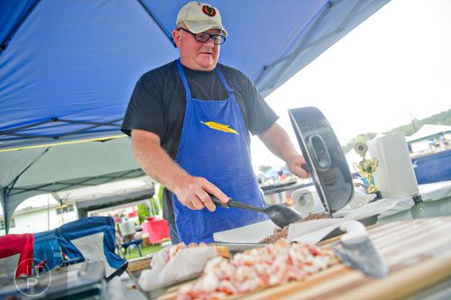 Hubie Vickers finishes cooking the meat to go inside of his chilli during the 11th Annual Flowery Branch Car Show and Chili Cook Off on Saturday, September 13, 2014. 