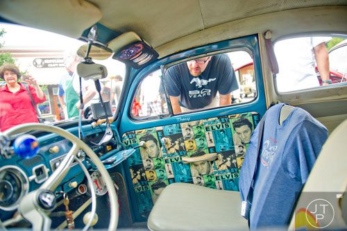 Wayne Yardley takes a peek inside a classic Volkswagen beetle during the 11th Annual Flowery Branch Car Show and Chili Cook Off on Saturday, September 13, 2014. 