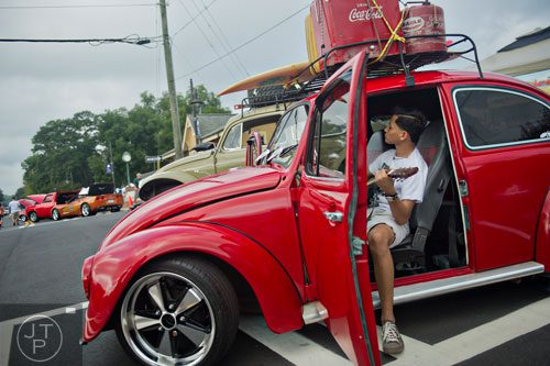Franklin Rodriguez plays guitar as he sits in a 1978 Mexican beetle during the 11th Annual Flowery Branch Car Show and Chili Cook Off on Saturday, September 13, 2014. 