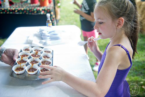 Keira Hoover reaches for a sample of chilli during the 11th Annual Flowery Branch Car Show and Chili Cook Off on Saturday, September 13, 2014. 