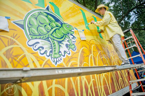 John Dunn paints the side of a truck during the Atlanta Arts Festival at Piedmont Park on Saturday, September 13, 2014. 