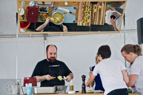 Chef Todd Ginsberg (left) gives a cooking demonstration during the Atlanta Arts Festival at Piedmont Park on Saturday, September 13, 2014. 