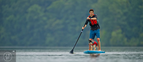 Tyler Legg and his Austrailan cattle dog Kora paddle board on the Chattahoochee River on Tuesday, August 19, 2014.