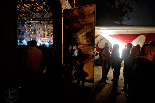 Fans stand both inside and outside at The Goat Farm in Atlanta as they wait in between sets on Saturday, October 4, 2014. 