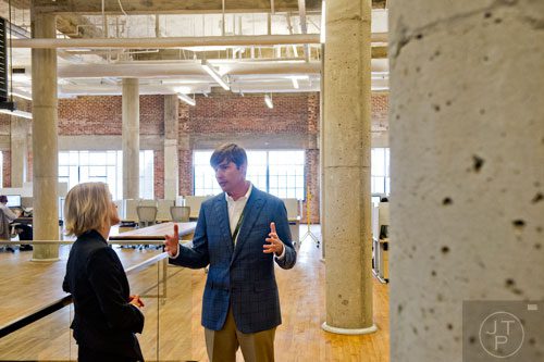 David Harvey (right) talks with Sandi Parker as he gives a tour of the 75,000 square foot offices of athenahealth at Ponce City Market in Atlanta on Tuesday, September 30, 2014. 