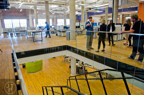 David Harvey (left) gives a tour of the 75,000 square foot offices of athenahealth at Ponce City Market in Atlanta on Tuesday, September 30, 2014. 