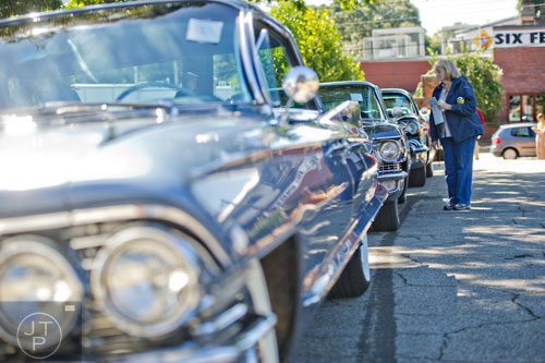 Karen Lynn Dominy looks at 60s era Cadillacs as she walks through Oakland Cemetery in Atlanta during the 35th annual Sunday in the Park on Sunday, October 5, 2014. 