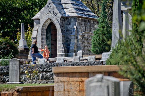Kristine Scott (left) helps her daughter Quincy down a set of steps in Oakland Cemetery in Atlanta during the 35th annual Sunday in the Park on Sunday, October 5, 2014. 