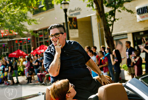 Honorary Grand Marshall Lea DeLaria plays up to the crowd as she rides a float down Peachtree St. during the Atlanta Pride Parade on Sunday, October 12, 2014. 