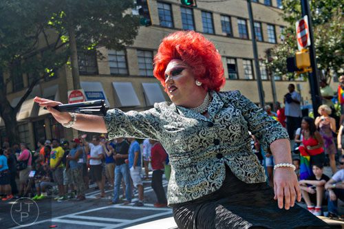 Ruby Redd waves to the crowd as she rides a float down Peachtree St. during the Atlanta Pride Parade on Sunday, October 12, 2014. 