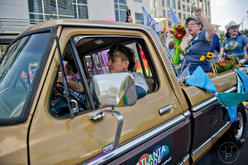 Mel Mushill (left) drives Ria Pell's truck down 10th St. during the Atlanta Pride Parade on Sunday, October 12, 2014. 