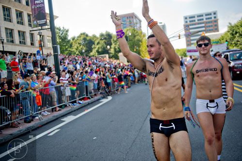 Brenner Bolton (center) and Dakota Wolfe march down 10th St. during the Atlanta Pride Parade on Sunday, October 12, 2014.