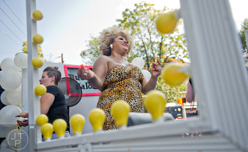 Shavonna Brooks (center) rides a float down 10th St. during the Atlanta Pride Parade on Sunday, October 12, 2014. 