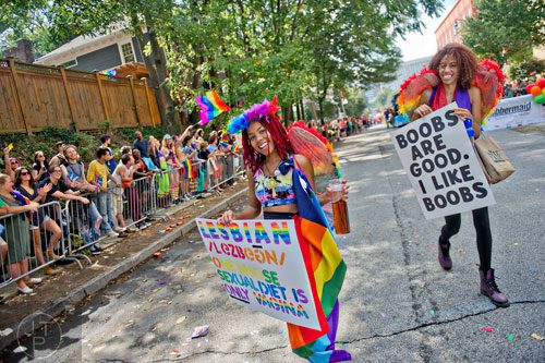 Marli Mims (left) and Brittney Holloway march down 10th St. during the Atlanta Pride Parade on Sunday, October 12, 2014.