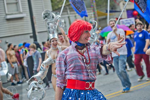 Tony Bayles (center) plays to the crowd as he marches down 10th St. during the Atlanta Pride Parade on Sunday, October 12, 2014. 