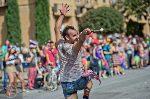Harley Stover twirls a baton as he marches down 10th St. during the Atlanta Pride Parade on Sunday, October 12, 2014. 