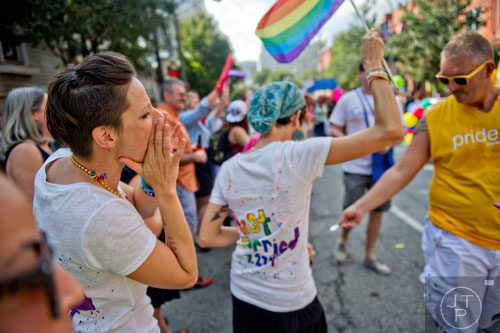 Rebekah Andras-Myers (left) cheers as she stands next to her wife Tiffany during the Atlanta Pride Parade on Sunday, October 12, 2014.
