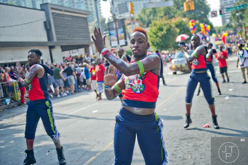 Wob Thorpe (center) dances down 10th St. during the Atlanta Pride Parade on Sunday, October 12, 2014. 
