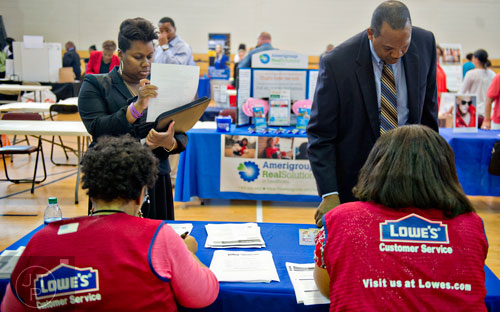 Krystal Flott (left) and Alan Harmon speak with Carolyn Beasley and Tracey Scott from Lowe's as they attend the South Clayton Job Fair at the South Clayton Recreation Center in Hampton on Tuesday, September 30, 2014. 