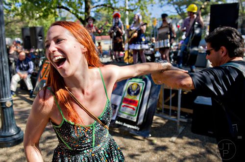 Stephanie Lloyd (left) dances with her husband David as The Hot House Peaches perform before the start of the 14th annual Little 5 Points Halloween Parade in Atlanta on Saturday, October 18, 2014. 