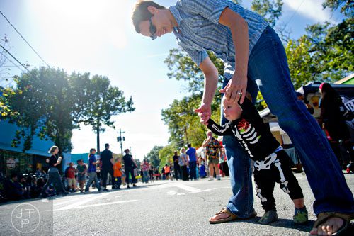 Tamara Aldridge (right) helps her son Drew Griggs walk across Euclid Ave. before the start of the 14th annual Little 5 Points Halloween Parade in Atlanta on Saturday, October 18, 2014. 