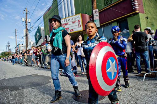 Staci Allen (left), Jacob Merrick and his brother Cole walk across Euclid Ave. before the start of the 14th annual Little 5 Points Halloween Parade in Atlanta on Saturday, October 18, 2014. 