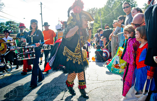 Shoshanna Baruch (right) plugs her ears with her fingers as the 14th annual Little 5 Points Halloween Parade in Atlanta passes by on Saturday, October 18, 2014. 