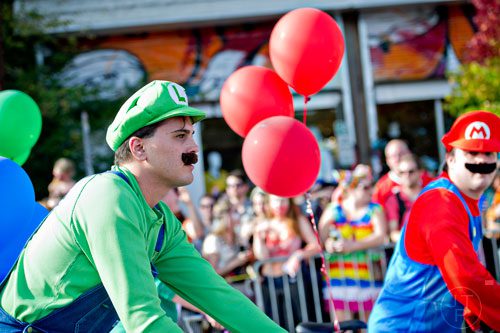 Dressed as Luigi, J.T. Masci (left) marches in the 14th annual Little 5 Points Halloween Parade in Atlanta on Saturday, October 18, 2014. 