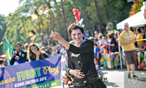 Rebecca Jennings (center) twirls fire as she marches in the 14th annual Little 5 Points Halloween Parade in Atlanta on Saturday, October 18, 2014. 