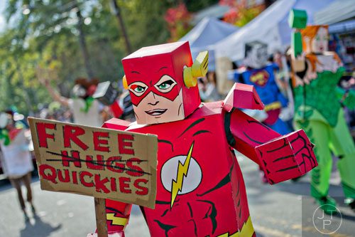 Dressed as The Flash, Mike Mualla (center) marches in the 14th annual Little 5 Points Halloween Parade in Atlanta on Saturday, October 18, 2014. 