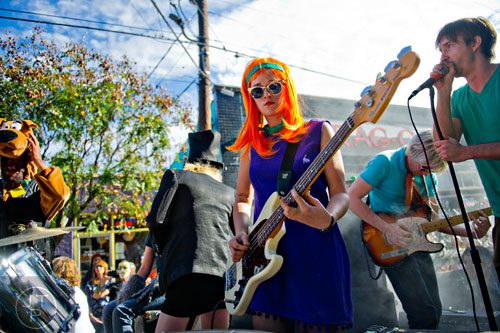 Dressed as Daphne from the Scooby Doo cartoon series, Erin Santini (center) plays a bass during the 14th annual Little 5 Points Halloween Parade in Atlanta on Saturday, October 18, 2014. 