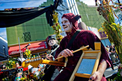Jason von Hinezmeyer (right) performs on the Center for Puppetry Arts float during the 14th annual Little 5 Points Halloween Parade in Atlanta on Saturday, October 18, 2014. 
