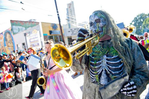 Christopher Manson (right) plays the trumpet as he marches in the 14th annual Little 5 Points Halloween Parade in Atlanta on Saturday, October 18, 2014.