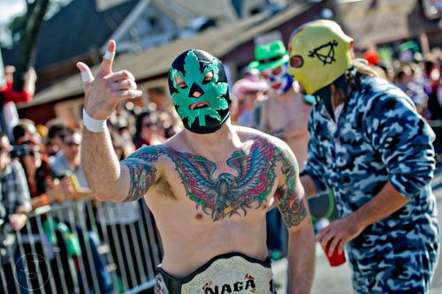 Dressed as a luchador, Josiah Neff (center) marches in the 14th annual Little 5 Points Halloween Parade in Atlanta on Saturday, October 18, 2014. 