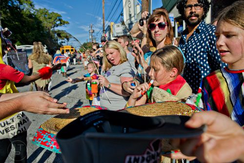 Catherine Jones (center) holds her hat out to get candy during the 14th annual Little 5 Points Halloween Parade in Atlanta on Saturday, October 18, 2014. 