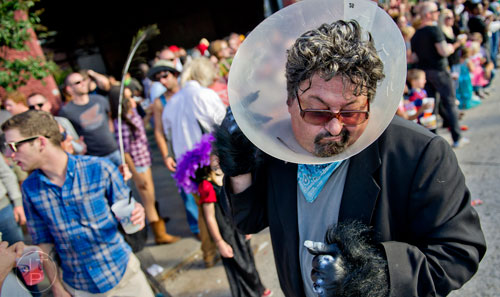 Thom Hecko (right) claws at the cone surrounding his head as he marches in the 14th annual Little 5 Points Halloween Parade in Atlanta on Saturday, October 18, 2014. 