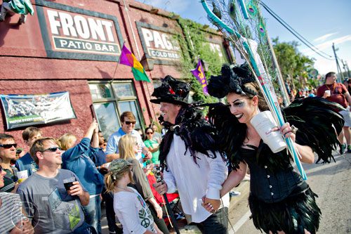 Rachael Brown (right) and her husband James cross Moreland Ave. during the 14th annual Little 5 Points Halloween Parade in Atlanta on Saturday, October 18, 2014. 