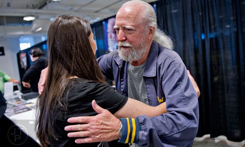 Scott Wilson (right), who portrayed Herschel on the Walking Dead, gives Vanessa Barfield a hug as he signs autographs during Walker Stalker Con in Atlanta on Sunday, October 19, 2014. 