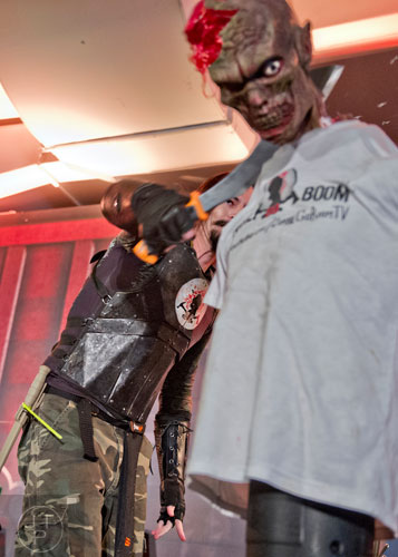 Chuck Mere tries to decapitate a zombie during Walker Stalker Con in Atlanta on Sunday, October 19, 2014.