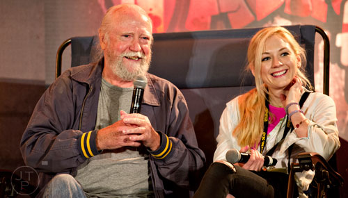 Scott Wilson (left) and Emily Kinney, who portray Herschel and Beth on the Walking Dead, talk to fans at a panel during Walker Stalker Con in Atlanta on Sunday, October 19, 2014.