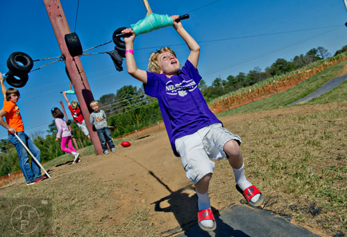 Casey Merritt flies through the air on a zip line at Corn Dawgs in Loganville on Sunday, October 5, 2014.