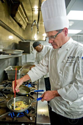Chef Russell Sleight prepares egg and ham quesadillas at The Cafe inside the Westin Peachtree Plaza hotel in Atlanta on Wednesday, October 8, 2014. 