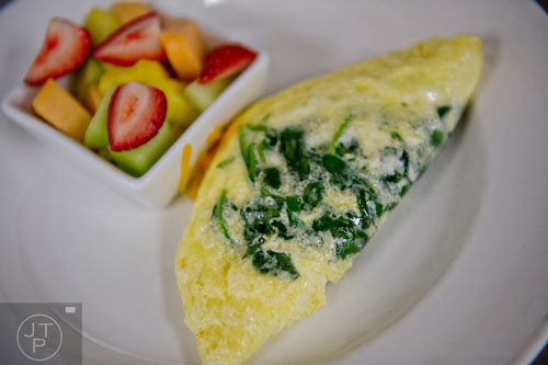 A pastel spinach omelette with a side of fresh fruit sits on a plate at The Cafe inside the Westin Peachtree Plaza hotel in Atlanta on Wednesday, October 8, 2014. 