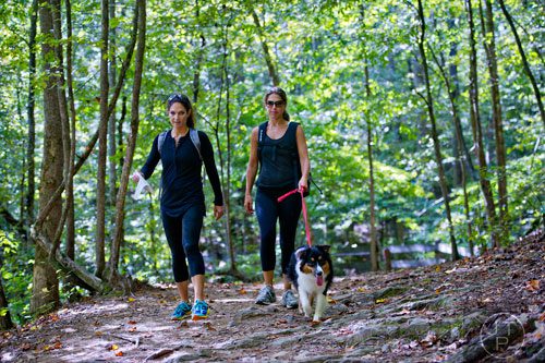 Elisa Kodish (left) hikes the trails at Sweetwater Creek State Park in Lithia Springs with Jennifer Leibowitz and her Australian shepherd  Cocoa on Monday, September 22, 2014.