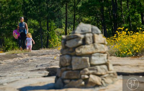 Marie Jones (left) and Elizabeth Clark follow the cairns that mark the path as they hike down Arabia Mountain in Lithonia on Wednesday, September 24, 2014.  