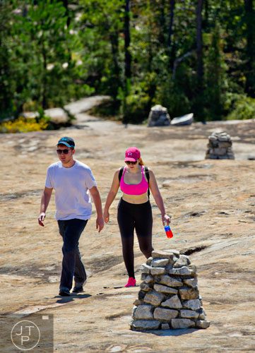 Alex Weinberg (left) and Sarah Cannon follow the cairns that mark the path as they hike up Arabia Mountain in Lithonia on Wednesday, September 24, 2014.