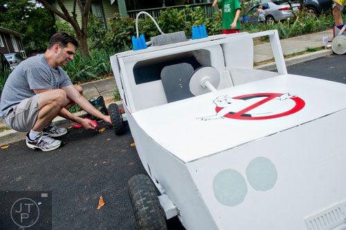 Greg Waldrop makes last minute adjustments to the braking system for the Ecto 1 from the movie Ghostbusters before the start of the 4th annual Madison Ave. Soap Box Derby in Decatur on Saturday, September 27, 2014.
